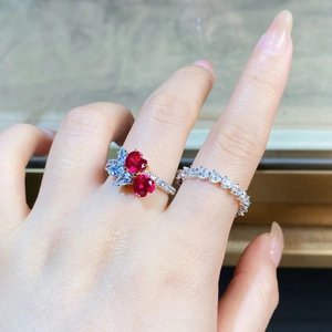 Detail of S925 silver ring featuring dual heart red rubies and shimmering zircon accents