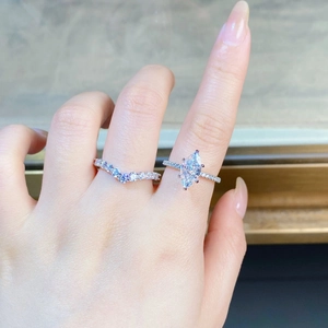 Macro shot of S925 silver marquise-cut engagement ring with chevron eternity band