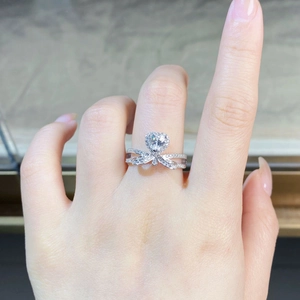 Detailed view of S925 silver heart moissanite ring featuring a bow-shaped diamond band