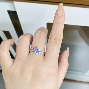 Close-up of 5 carat moissanite ring with twisted band and pave diamonds on hand