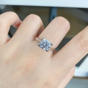 Macro shot of 2 carat square-cut moissanite ring with classic four-prong silver setting