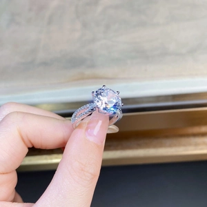 Macro view of a six-prong setting 5-carat moissanite ring with double-row diamond band