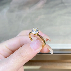 Detail of a 18K gold plated S925 silver ring featuring classic six-prong moissanite setting