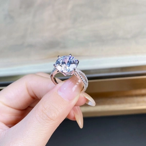 Macro shot of 5 carat moissanite ring featuring six-prong setting and pavé twisted band