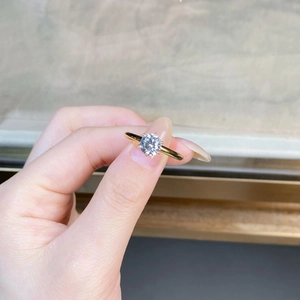 Detail of a 1-carat round moissanite ring with six-prong setting in 18K gold finish