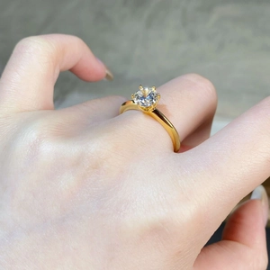 Detail view of a 18K gold-plated S925 silver ring featuring a six-prong moissanite setting