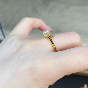 Detailed view of a classic 6-prong gold-plated silver ring with 1ct moissanite diamond