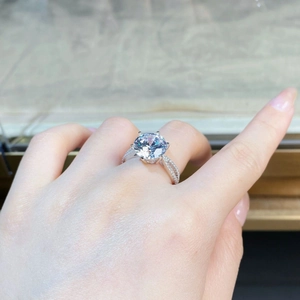 Detailed close-up of 5-carat round moissanite ring with six-prong setting and twisted band