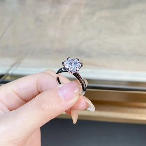 Close-up of a classic six-prong 925 silver ring with a round moissanite stone