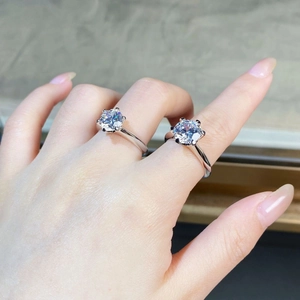 Macro detail of classic six-prong and four-prong silver moissanite rings set