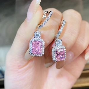 Macro shot of S925 silver earrings with radiant cut pink stones and pavé diamonds