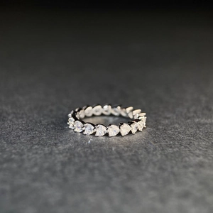Macro shot of S925 sterling silver full eternity ring featuring heart-cut cubic zirconia