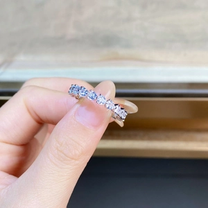 Macro shot of S925 silver ring featuring heart-cut diamonds in a continuous pavé setting