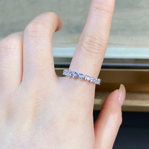 Close-up of S925 sterling silver eternity band with heart-cut crystals on finger