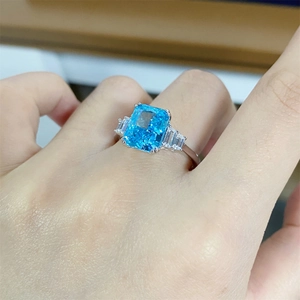 Macro view of 4ct aquamarine ice flower cut ring with classic four-prong setting