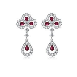 Detail of silver clover earrings with red pear-cut stones and white zircon accents