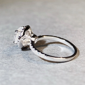 Exquisite 925 silver moissanite ring with a brilliant round center stone and pave band