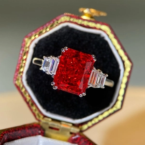 Macro view of vintage silver ring with rectangular red zircon in an octagon jewelry box