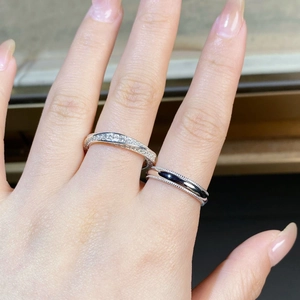 Close-up of S925 sterling silver couple rings with micro-pave stones and black enamel inlay