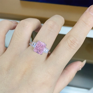 Macro detail of 925 silver ring featuring a radiant emerald-cut pink zirconia stone