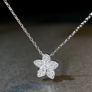 Macro close-up of S925 silver daisy necklace pendant with sparkling white zircon stones