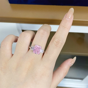 Macro detail of radiant cut pink zircon ring with 925 silver band on female hand