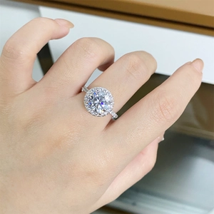 Macro shot of a classic halo engagement ring with round moissanite in silver setting