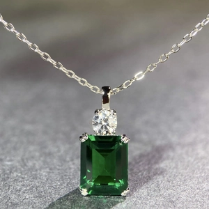 Macro shot of emerald cut green gemstone pendant with O-chain in S925 sterling silver