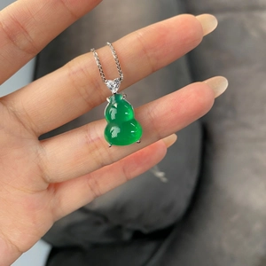 Hand holding a green chalcedony gourd pendant on a 925 silver chain necklace
