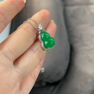 Macro shot of S925 silver necklace with green chalcedony gourd pendant and cubic zirconia
