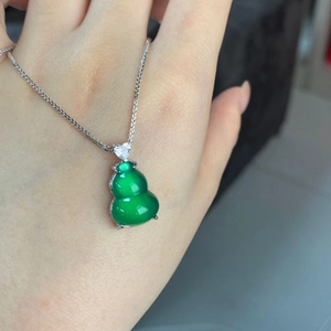 Detail of green chalcedony gourd pendant with silver chain and heart zircon accent