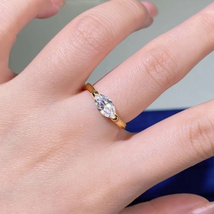 Close-up of marquise-cut marquise moissanite ring with two-prong gold setting