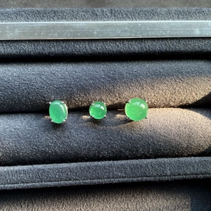 Macro shot of S925 silver stud earrings with round emerald green chalcedony gemstones
