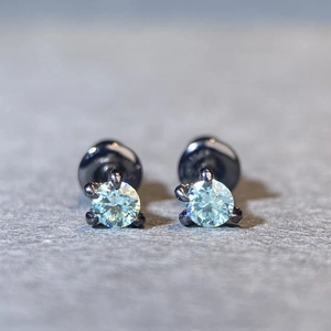 Macro view of gunmetal dragon claw stud earrings featuring sparkling round stones