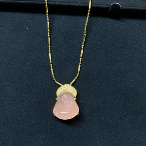 Detail of pink crystal Maitreya Buddha pendant with sparkling pavé diamonds on gold chain