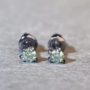 Detailed view of light green moissanite earrings with four-prong S925 silver setting