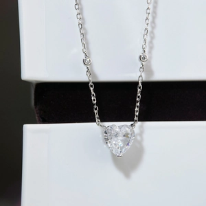 Macro shot of S925 sterling silver heart-cut pendant necklace on elegant jewelry box