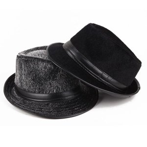 Close-up of stacked faux mink fur fedora hats featuring decorative leather bands and textures