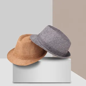 Classic linen fedora hats in brown and grey displayed on a modern minimalist pedestal