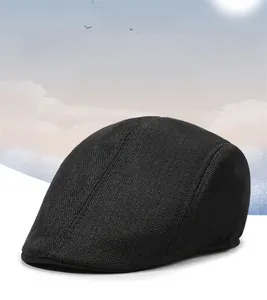 Detail of black linen flat cap showing breathable mesh texture and structured brim