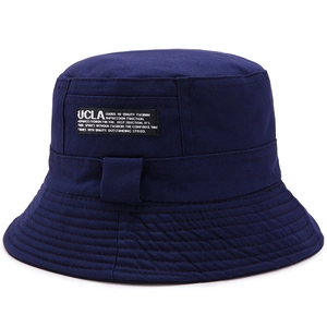 Navy blue reversible cotton bucket hat featuring UCLA embroidered patch on white background