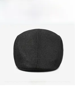 Close-up front view of black woven linen flat cap showing fine material texture