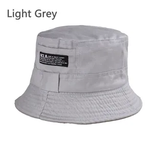 Detailed close-up of light gray cotton bucket hat stitching and UCLA woven label logo