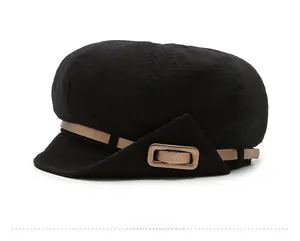 Side view of black newsboy hat with breathable texture and khaki decorative strap