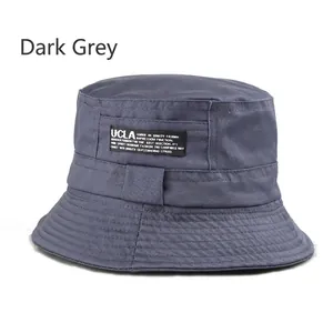 Detail of dark gray cotton bucket hat featuring UCLA woven label and reinforced stitching