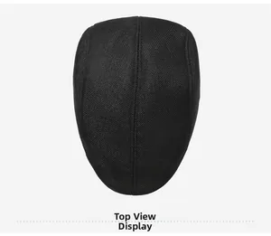 Top view of a black flat cap showing detailed twill weave and stitching quality