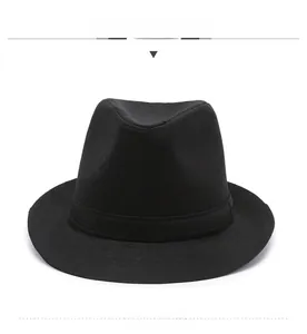 Detailed front view of a black classic fedora with textured fabric and decorative band