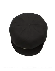 Top-down view of a black textured newsboy cap with classic paneled crown construction