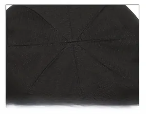 Macro shot showing detailed radial stitching and durable fabric texture on top of black hat