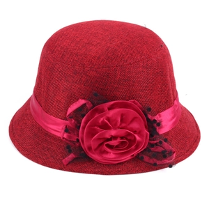 Detail of red linen cloche hat with silk rose flower and black polka dot mesh veil